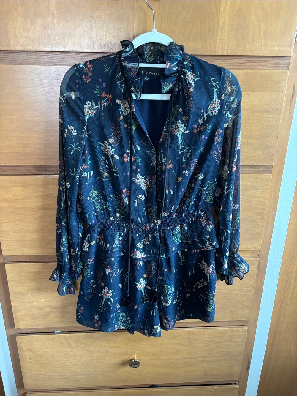 Adelyn Rae Navy Floral Long-Sleeve Romper with Tie Neck